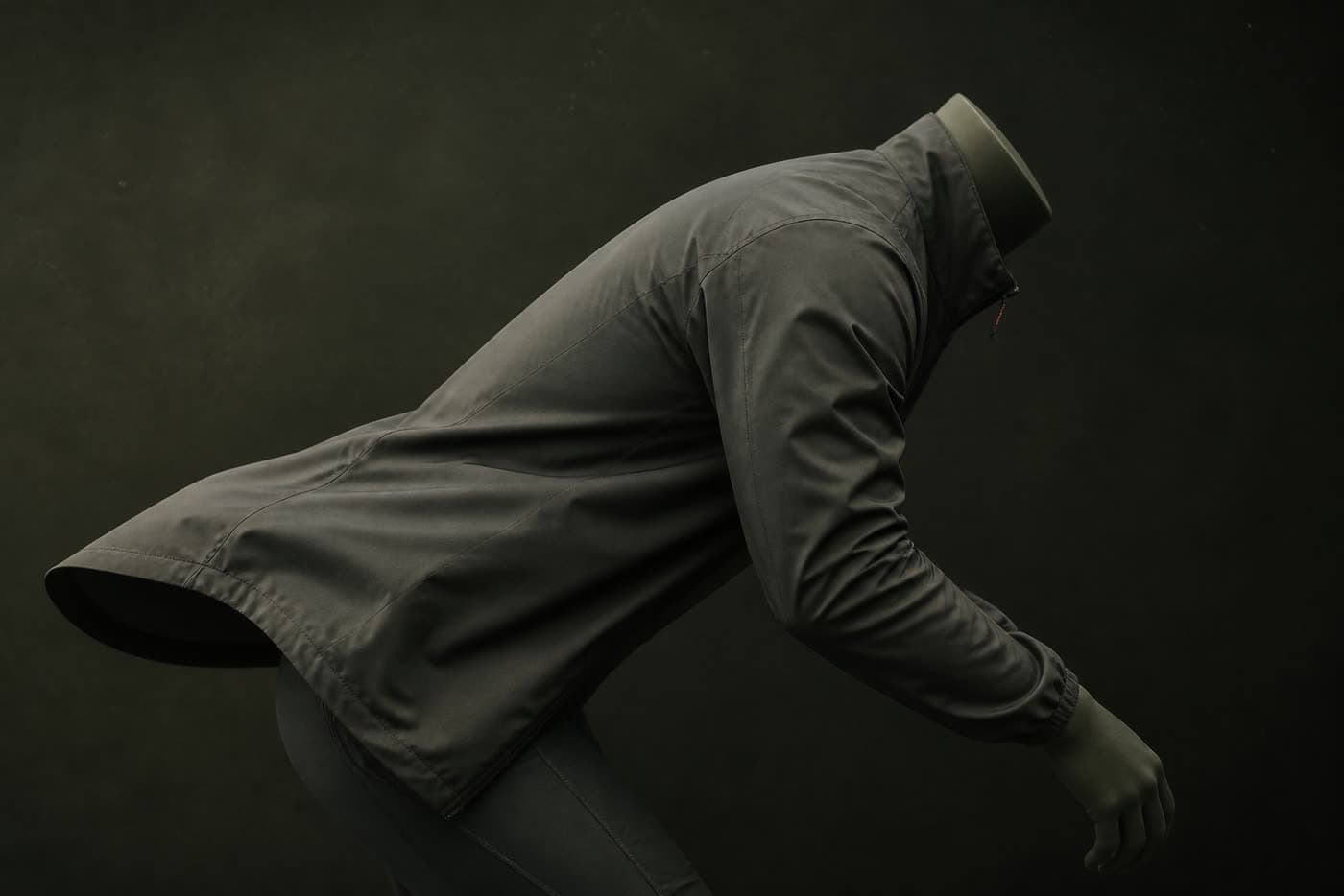 A garment on a mannequin bent forward at 35 degrees, showing the back hem lifting and the sleeve pulling back